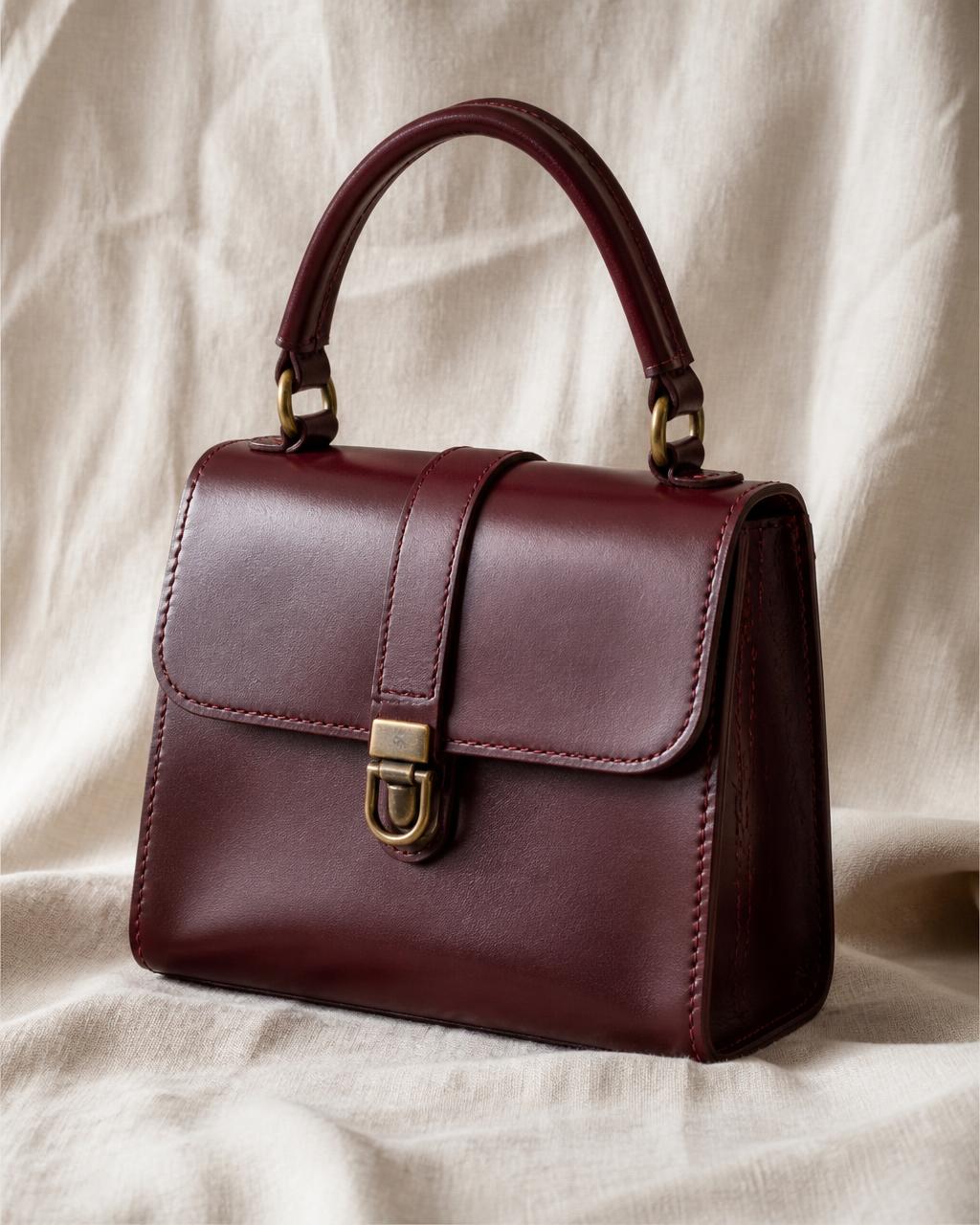 Burgundy Italian leather top-handle bag on linen
