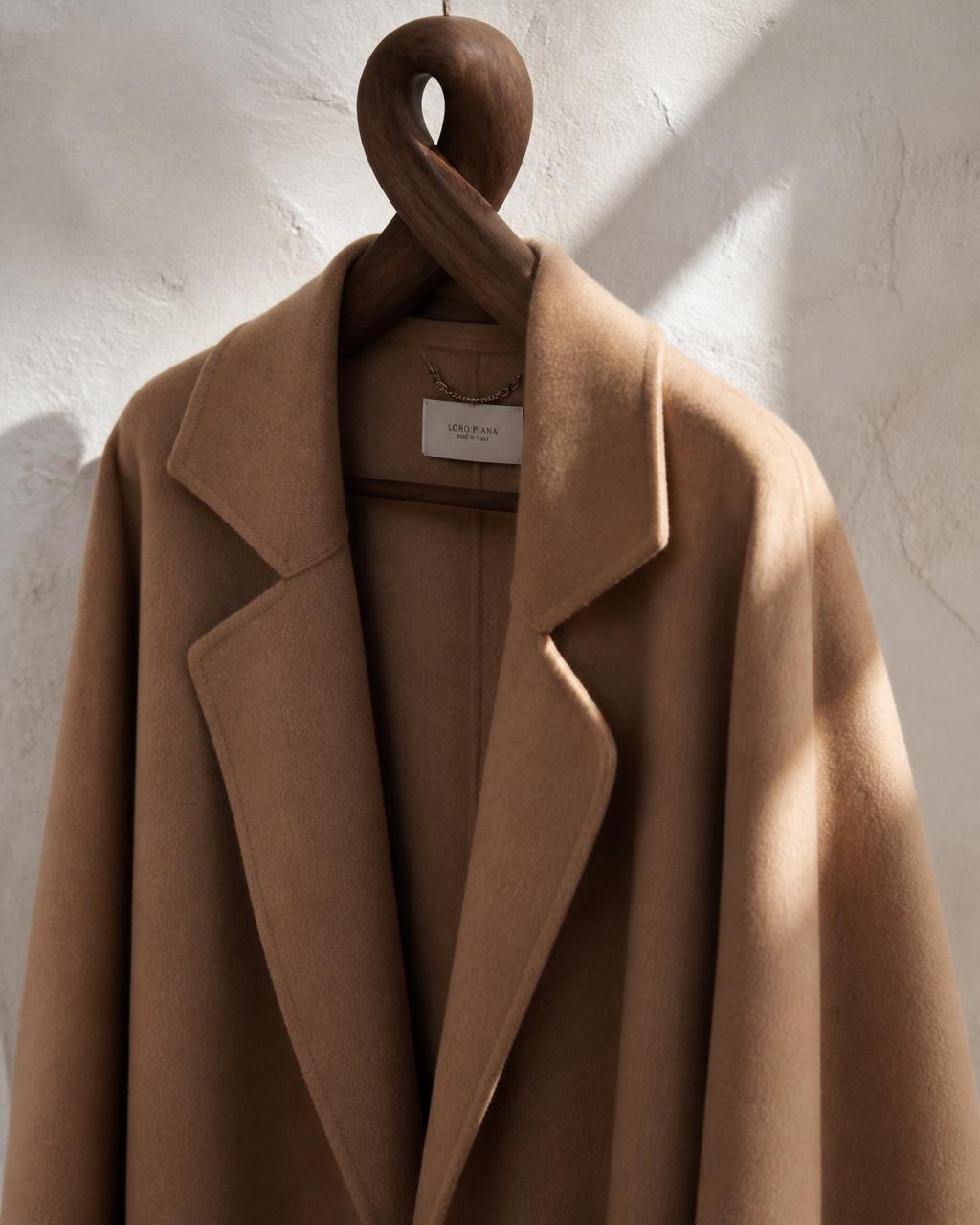 Camel double-face wool and cashmere coat on a wooden hanger