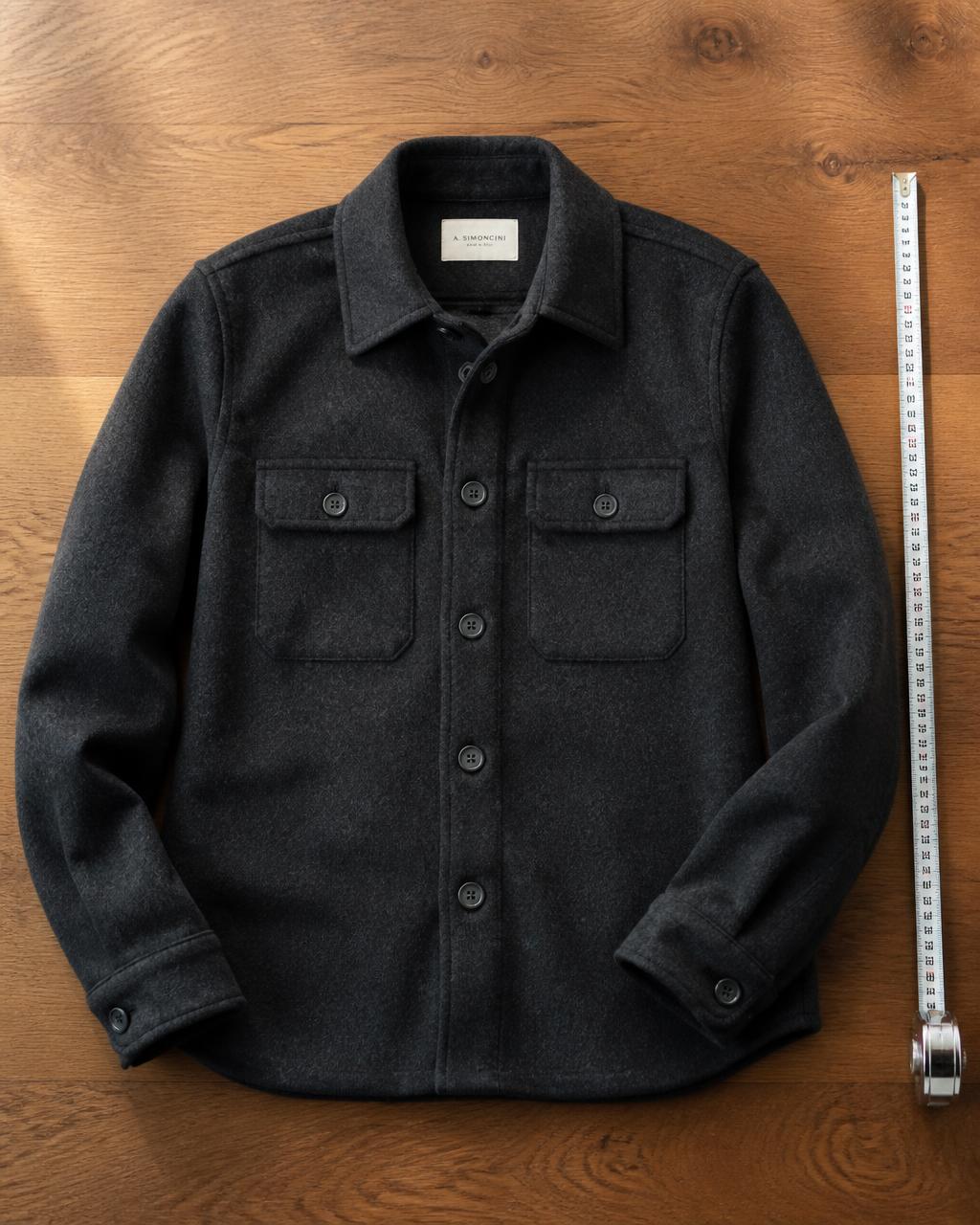 Charcoal brushed wool overshirt laid flat on an oak table